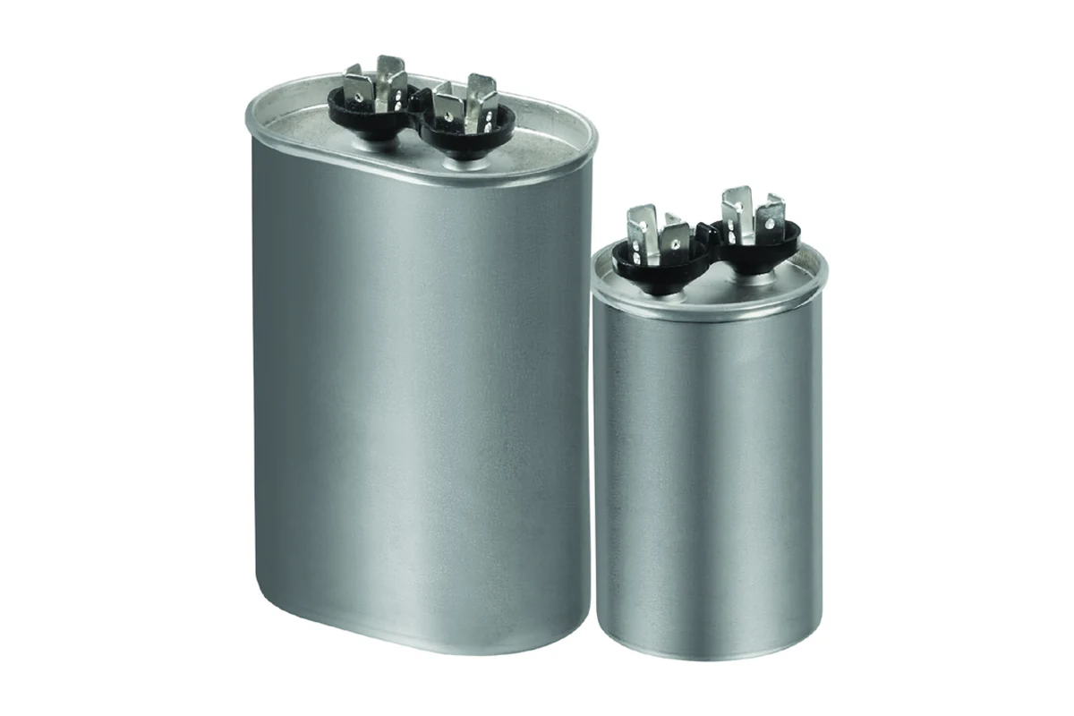 Oval and round metal motor-run capacitors with quick-connect terminals on top