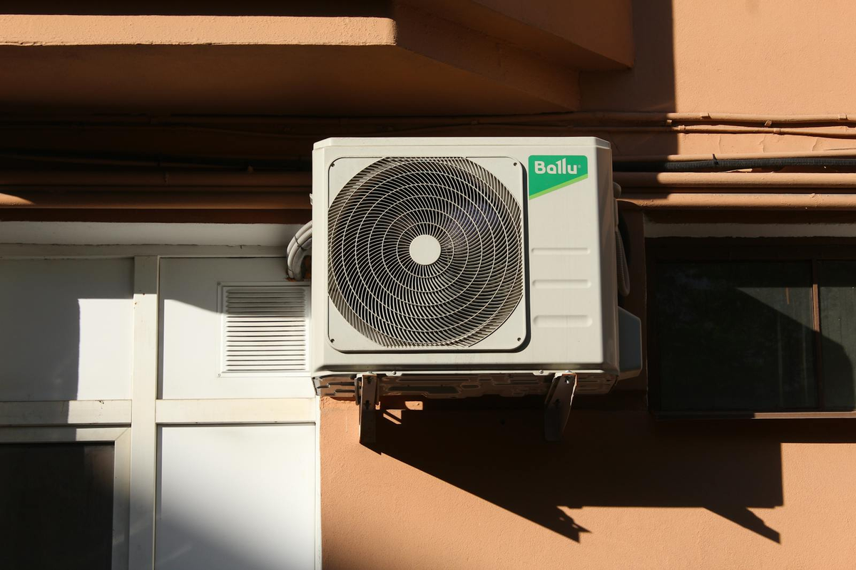 Outdoor AC condenser unit mounted on a South Florida home