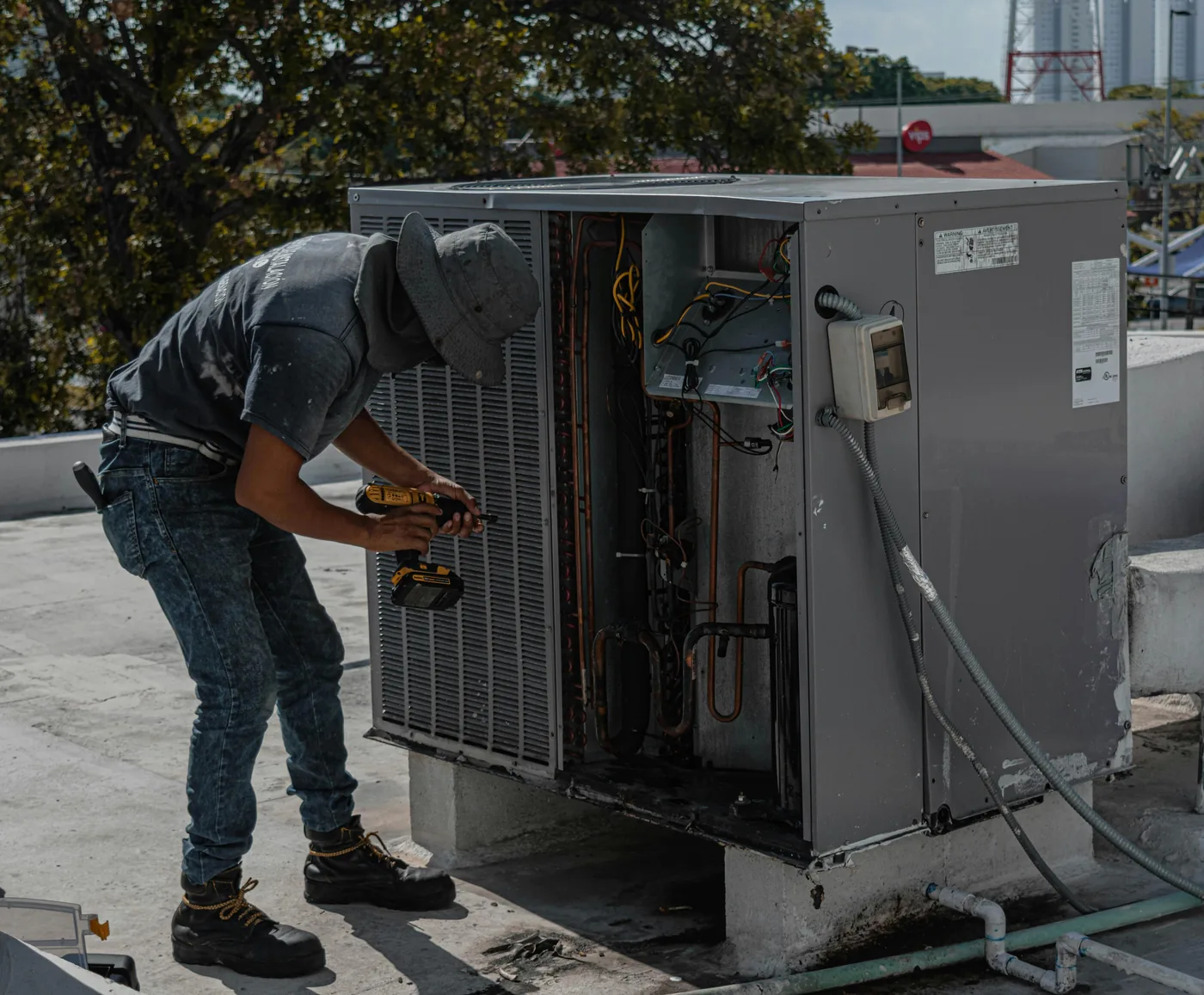 Close-up of a residential AC condensing unit being serviced, the kind of mid-life repair call where compressor diagnosis happens