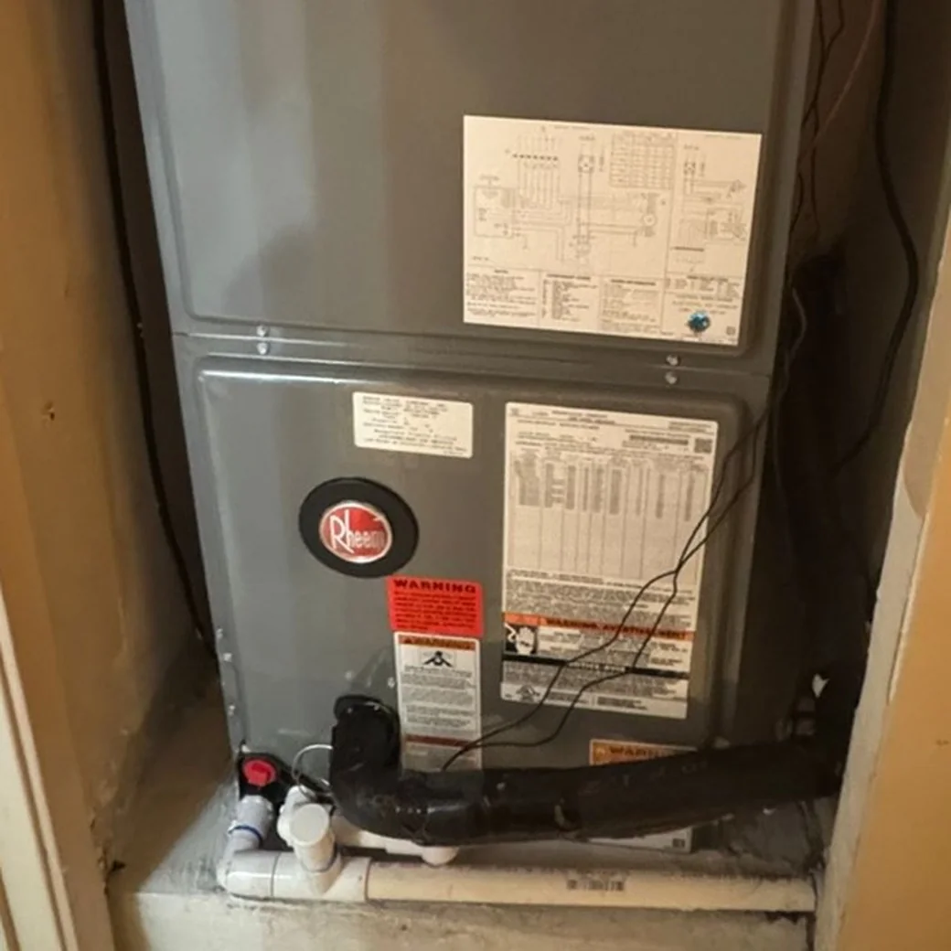 Indoor air handler cabinet in a hallway closet with two access panels and the data plate visible