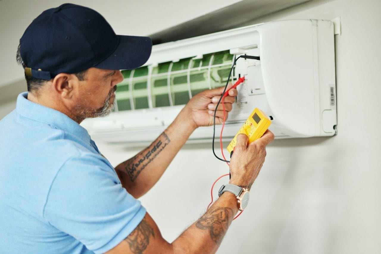 Florida HVAC technician performing AC maintenance tune-up