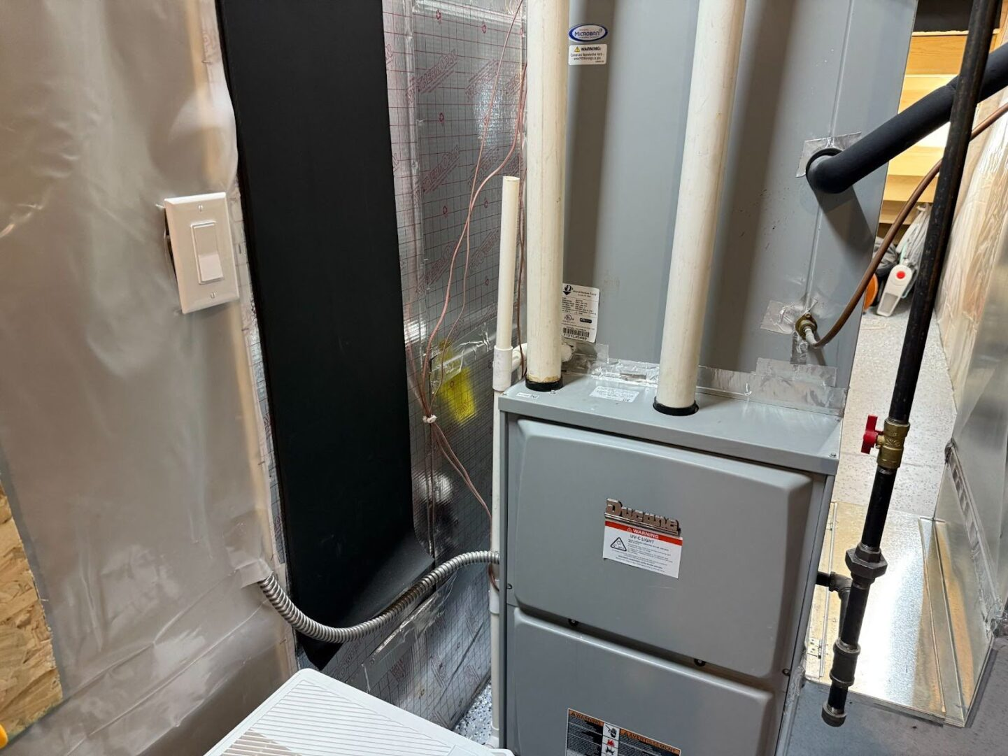 Technician inspecting AC coils before cleaning process