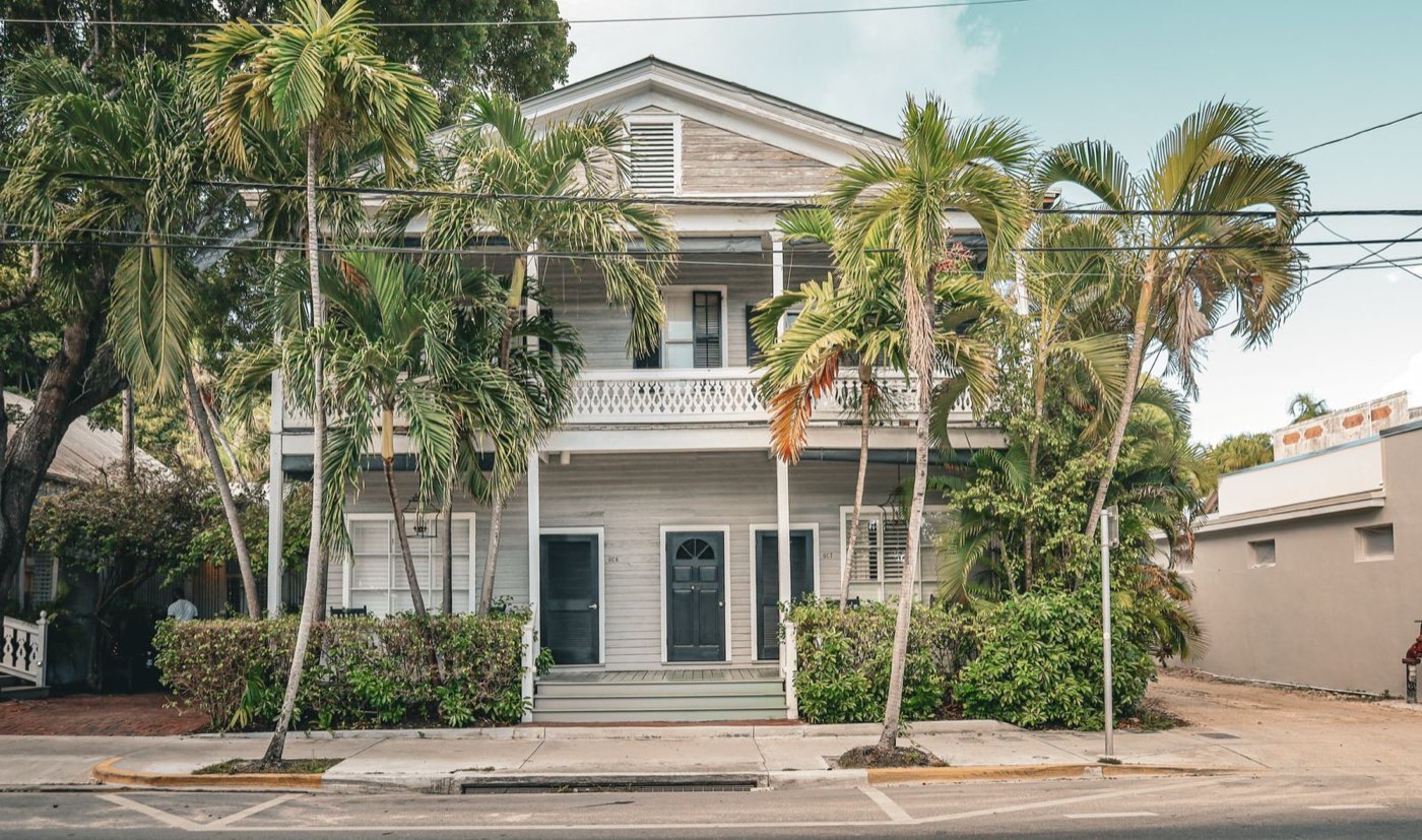 Classic South Florida home with palm trees, Key West style residential architecture