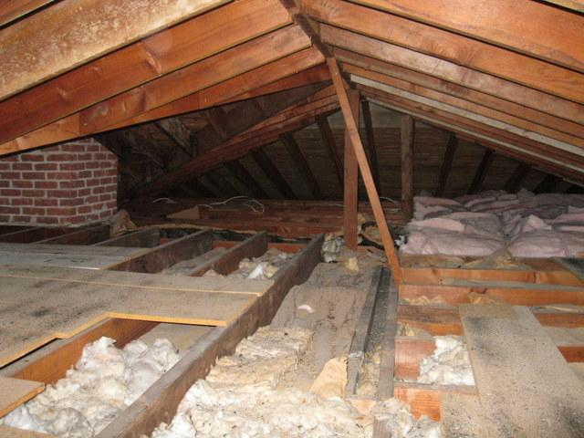 Contaminated attic insulation with dust and debris buildup