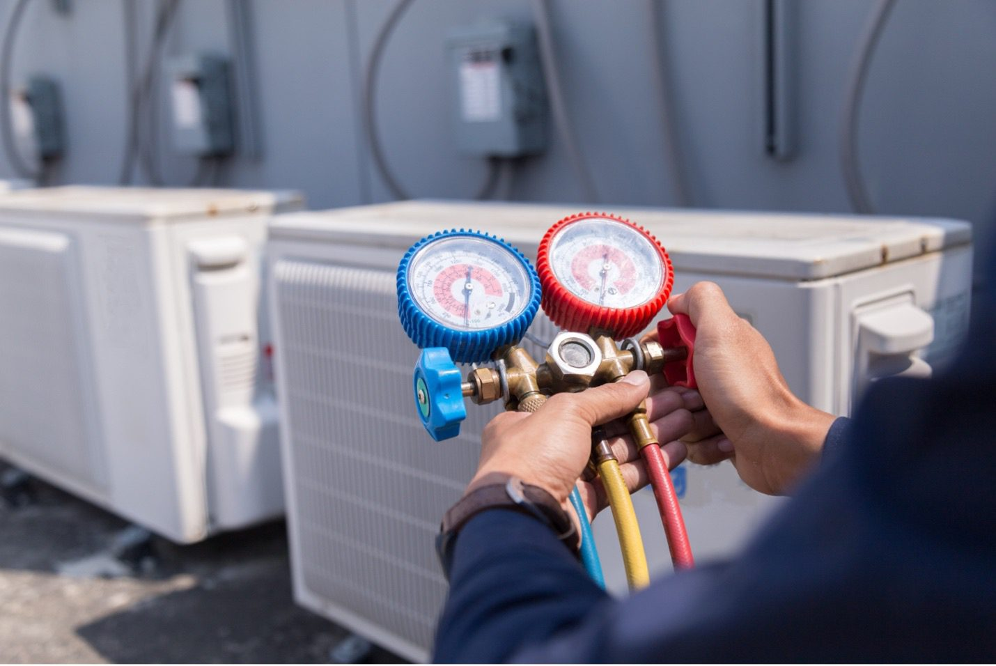 Professional HVAC technician calibrating a newly installed split AC system