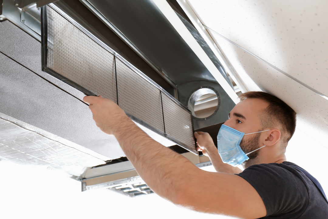 HVAC technician cleaning AC coils