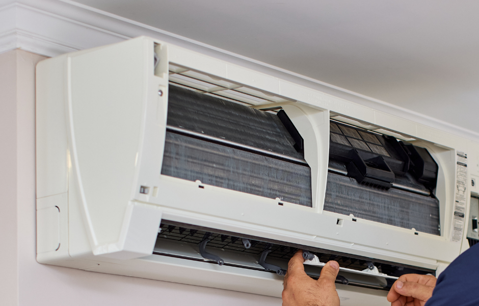 HVAC technician servicing an outdoor AC condenser unit
